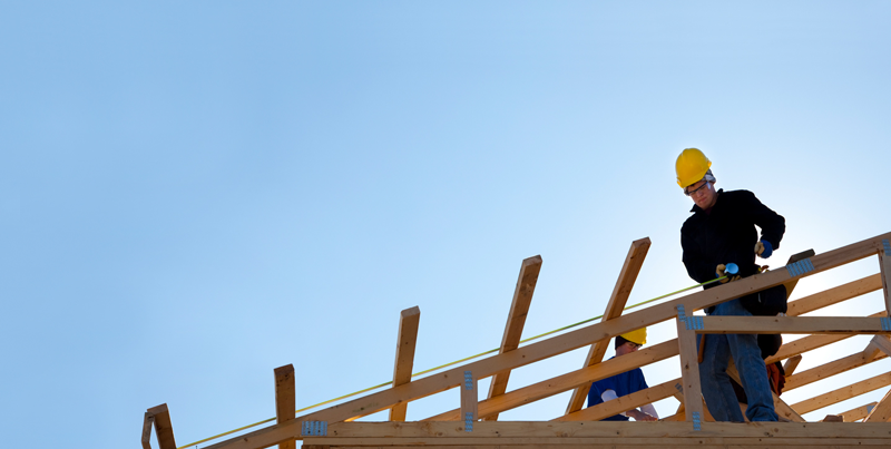 man working on the roof at the construction site