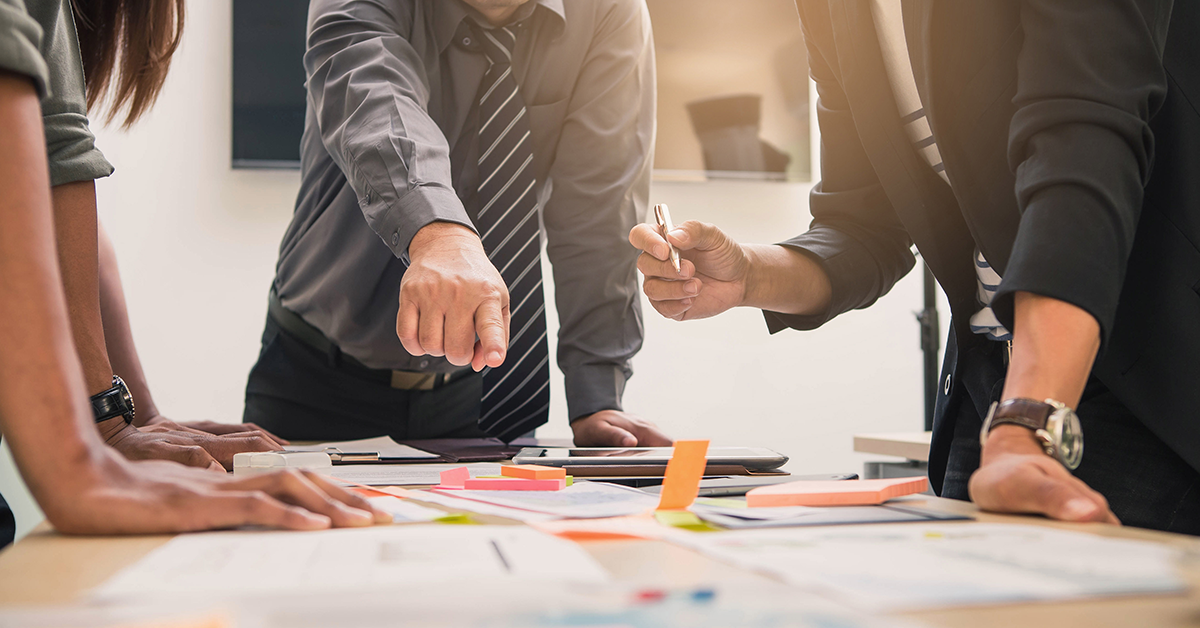 Man pointing finger on the marketing materials on the desk in the meeting