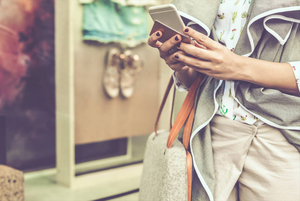 woman holding mobile phone shopping