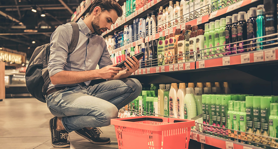 man looking at consumer product at a grocery store