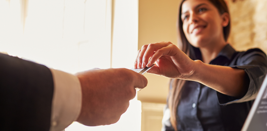 cashier handing credit card back to customer - sales person