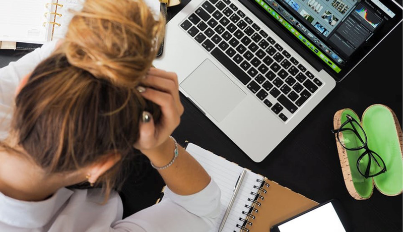 woman with her hands on her head frustrated