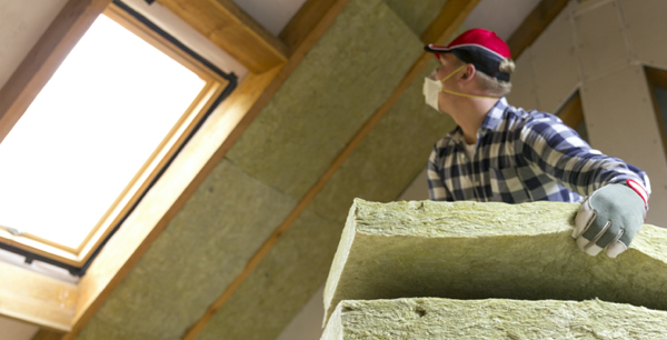 construction worker putting insulation in the house building site