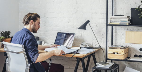 young man working from home on his desk