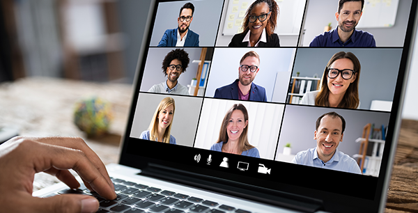 A laptop showing virtual conference meeting participants